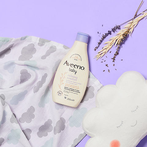 AVEENO® Baby Calming Comfort Range with lavender situated with cloud cushion and blanket